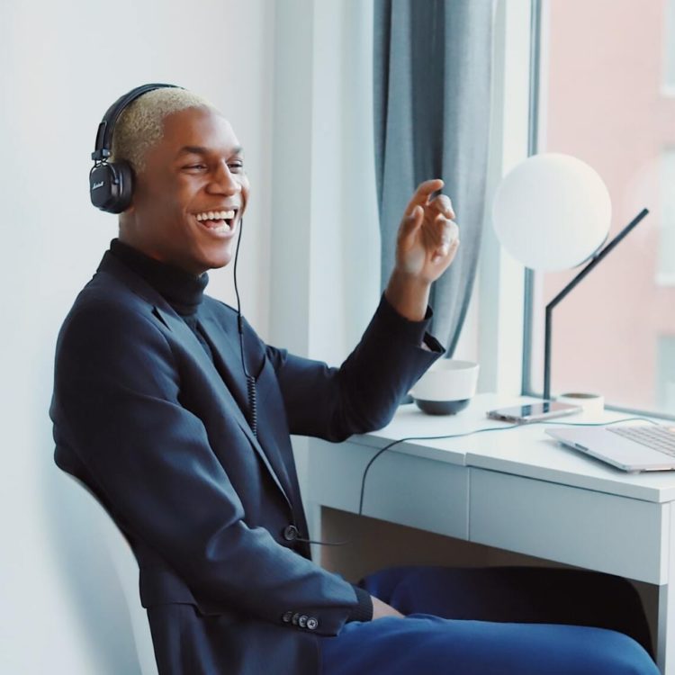 man smiling with headphones on